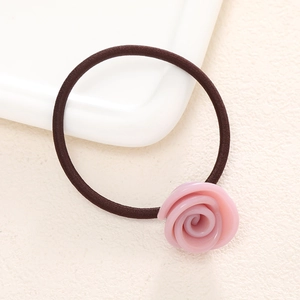 Close-up of pink resin rose charm on high-elasticity brown hair tie accessory