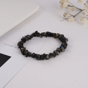 Macro shot of irregular natural grey labradorite crystal stones on a stretch bracelet