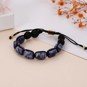 Detail of adjustable woven yoga bracelet with sodalite stones and black lava beads