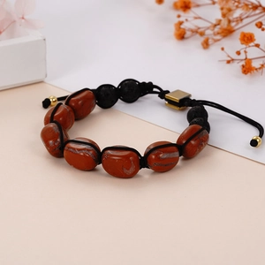 Detailed view of handmade woven yoga bracelet with red jasper and black lava stones
