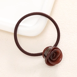 Close-up of elegant dark red resin rose hair tie with high-elasticity coffee nylon band