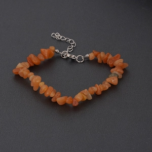 Detailed close-up of natural irregular orange carnelian stone chips bracelet with silver clasp