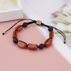 Detail view of woven yoga bracelet with oval red jasper and black lava stone beads