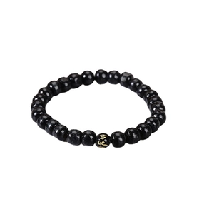 Men's handmade black beaded bracelet with gold Buddhist mantra engraving on a focal bead