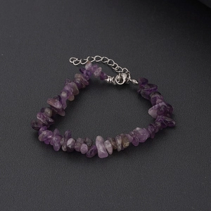 Handmade amethyst crystal chip bracelet with adjustable silver lobster clasp on black background