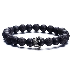 Lava rock and matte black beaded bracelet featuring a vintage silver crown charm