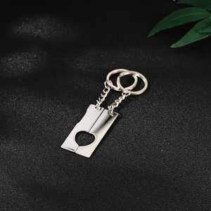 Macro shot of mirror-polished stainless steel heart-shaped puzzle pendant keychains