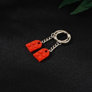 Two red building block heart keychains in a couple set made of premium ABS plastic
