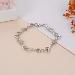Unisex silver thorn chain bracelet with punk industrial aesthetic and lobster clasp