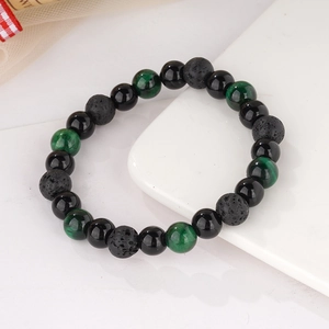 Detail of 8mm black agate, tiger eye and lava stone beads on a yoga bracelet