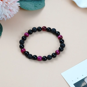 Detailed shot of 8mm lava rock, black agate and purple tiger eye beads yoga bracelet