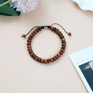 Adjustable woven bracelet featuring brown tiger eye stone beads and silver accent beads