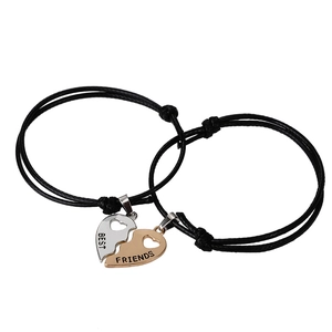 Matching heart pendant bracelets in black woven rope for couples and best friends