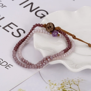 Bohemian multilayer woven bracelet with purple faceted crystals and wooden button closure
