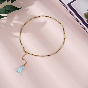 Long stainless steel necklace with green natural stones and a blue silk tassel pendant