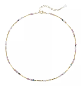 Close-up of natural stone colorful beads and golden clasp of the long tassel necklace