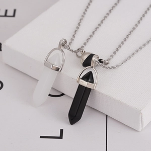 Close-up of magnetic hexagonal crystal pendants in black and white on a gift box