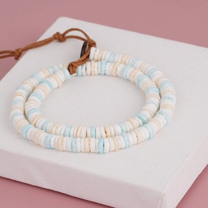 Bohemian handmade Heishi bead bracelet with blue and white shell spacers on woven cord
