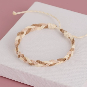 Macro detail of Bohemian hand-woven adjustable cord bracelet with braided earthy textures