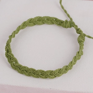 Handmade bohemian olive green braided rope bracelet with adjustable tassel cord closure