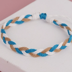 Detailed macro view of bohemian hand-woven tricolor blue white and khaki adjustable bracelet