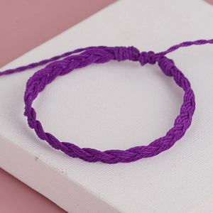Handmade purple bohemian woven bracelet with adjustable sliding knot and tassel detail