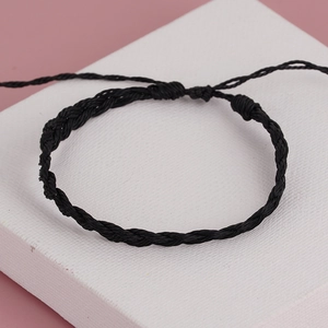 Detailed view of handmade black braided rope bracelet with adjustable sliding knot closure