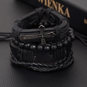 Detail showing 4-piece black leather bracelet set with cross charm and matte beads