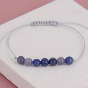 Handmade woven yoga bracelet with seven natural blue and purple crystal beads on lavender cord