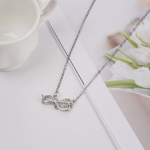 Elegant silver bow pendant necklace with sparkling zircons on a delicate chain