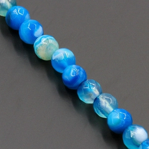 Macro shot of faceted blue striped agate beads with natural stone texture for jewelry