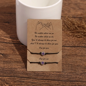 Close-up of luminous heart beads on adjustable friendship bracelets on gift card