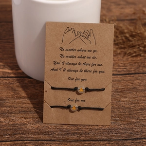 Luminous heart charms on black adjustable friendship bracelets with a message card