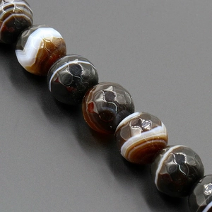 Macro shot of faceted striped agate beads showing natural textures and polished surfaces