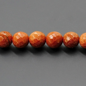 Macro view of 4-10mm faceted goldstone beads showing shimmering metallic texture