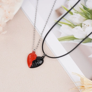 Detail of heart puzzle necklaces with For Ever engraving and magnetic connection