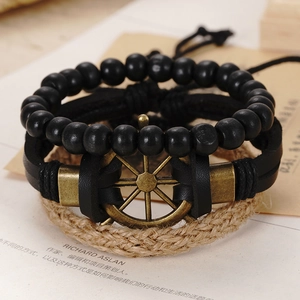 Macro view of vintage multilayer bracelets with bronze rudder charm and black beads