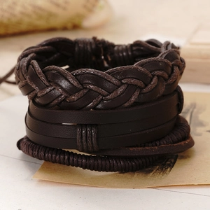 Macro view of multi-layer retro woven leather bracelet set with brown cord textures