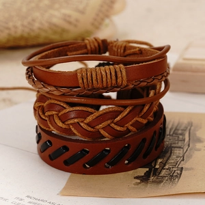 Close-up detail of three-piece vintage leather bracelet set with woven texture