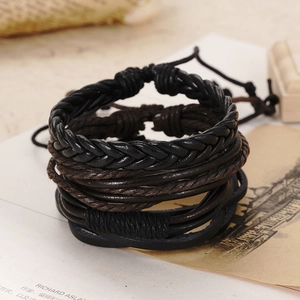 Close-up of vintage braided leather bracelet set with woven textures and adjustable knots