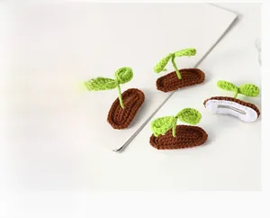 Close-up of handmade crochet bean sprout hair clips with leaf detail and metal base
