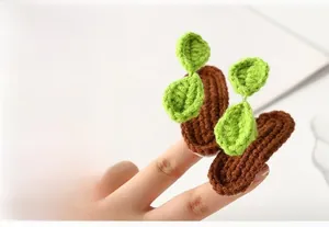 Close-up of handmade knitted sprout hair clip showing green leaf crochet detail