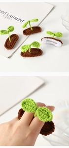 Close-up of handmade crochet sprout hair clip featuring green leaves and brown soil base