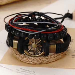 Close-up of vintage multi-layer leather bracelet set with bronze anchor and wood beads