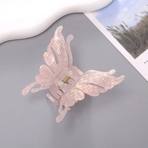 Pince à cheveux papillon élégante en acétate rose-violet irisé avec des strass brillants
