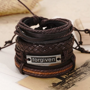 Close-up of vintage multi-layer brown leather bracelet with metal forgiven engraving