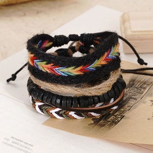 Detail of four-piece retro handmade braided leather and wooden bead bracelet set