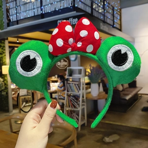Cute green plush frog headband for girls with oversized red polka dot bow decoration