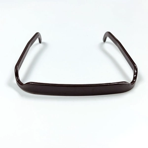 Close-up of deep brown resin headband with a unique sunglasses-shaped design and glossy finish