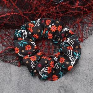 Close-up of Halloween scrunchie with skull hand print and spider web background